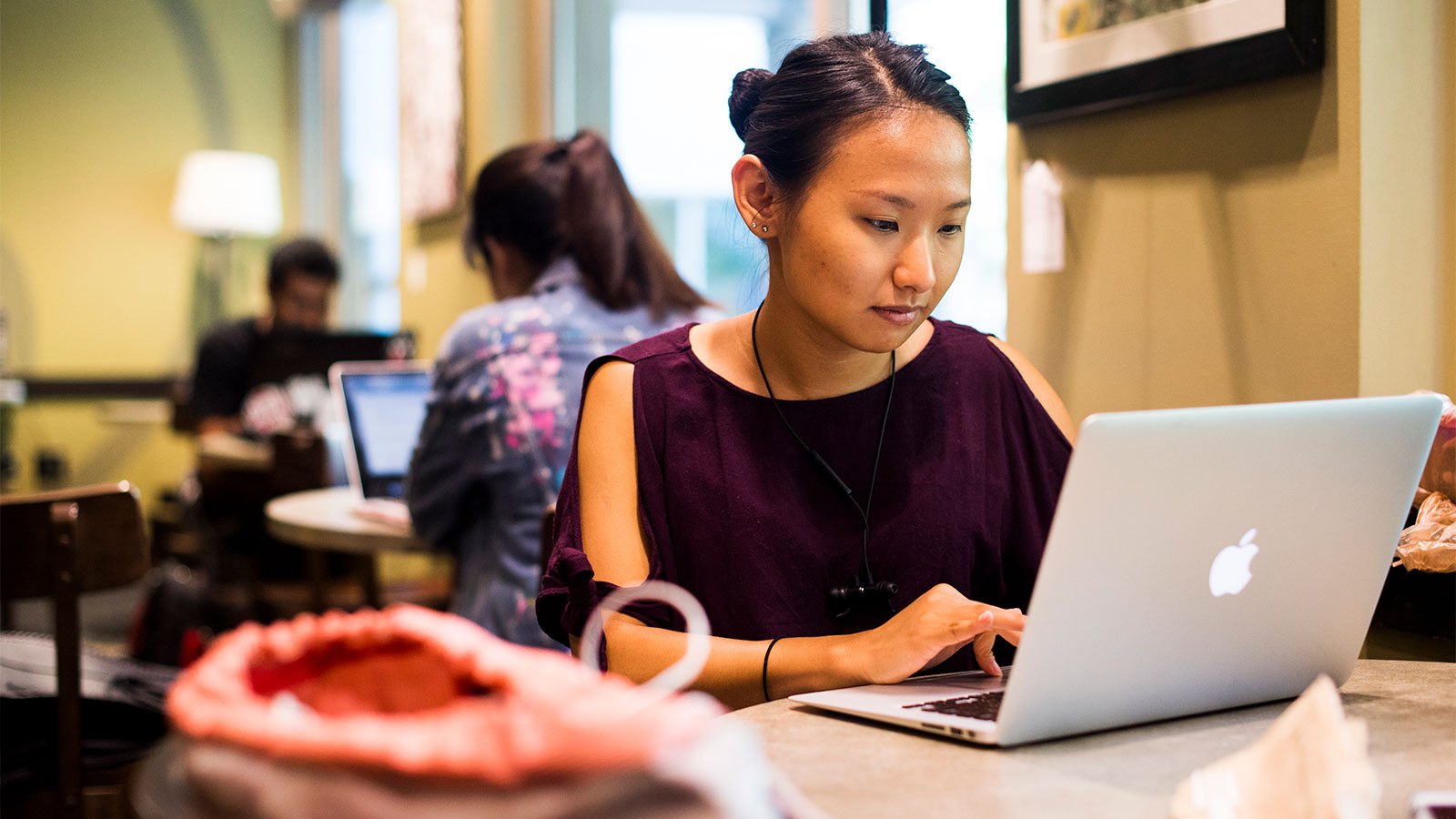 asian woman working at on a laptop